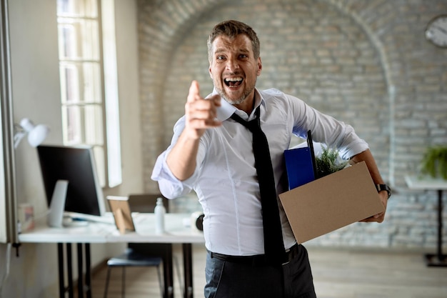 Angry businesswoman pointing at his index finger and screaming after getting fired from work