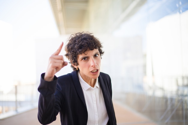 Angry businesswoman pointing with finger