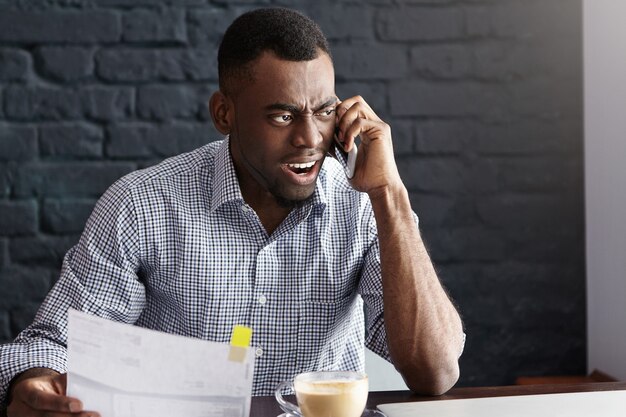 Angry Chief Executive Officer in formal shirt holding piece of paper