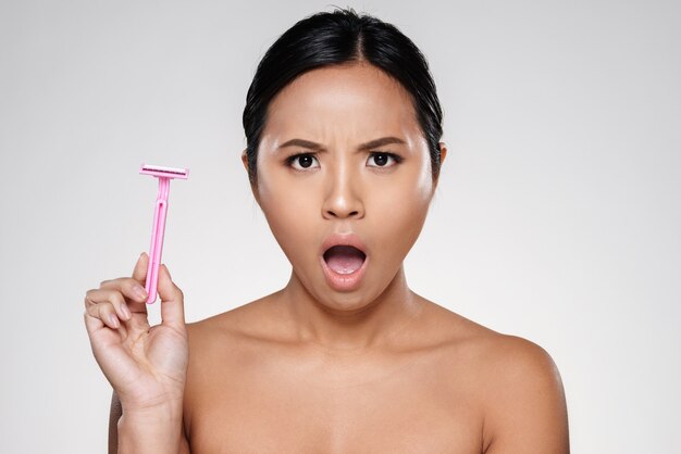 Angry displeased lady holding razor