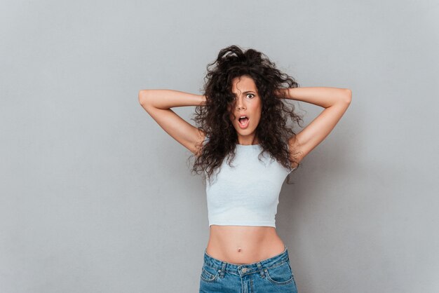 Angry displeased woman looking camera with opened mouth