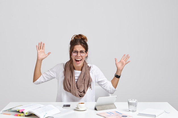 Free photo angry female boss gestures with annoyance and exclaims negatively