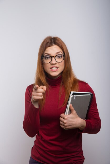Angry female student pointing with finger
