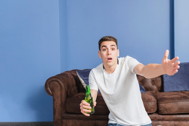 Angry football fan in front of couch