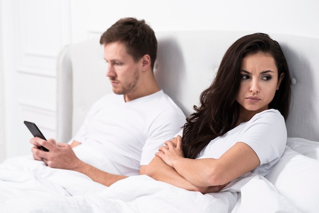 Angry girlfriend staying next to her boyfriend