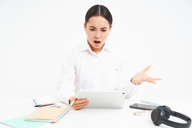 Angry korean woman shouting at employee on video chat has intense conversation online looks frustrat