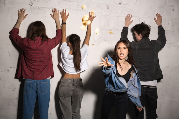 Free photo angry lady standing and throwing bread with friends