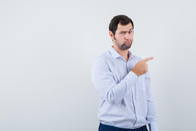 The angry man is pointing to right with his forefinger on white background