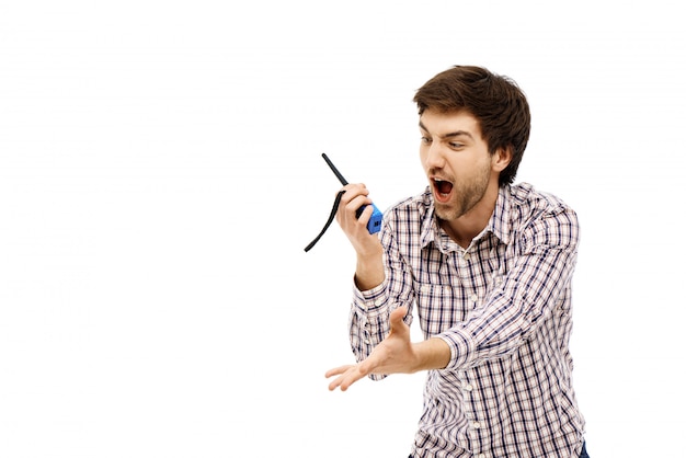 Angry man shouting at radio transmitter