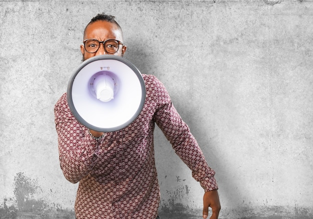 Free photo angry man shouting through a megaphone