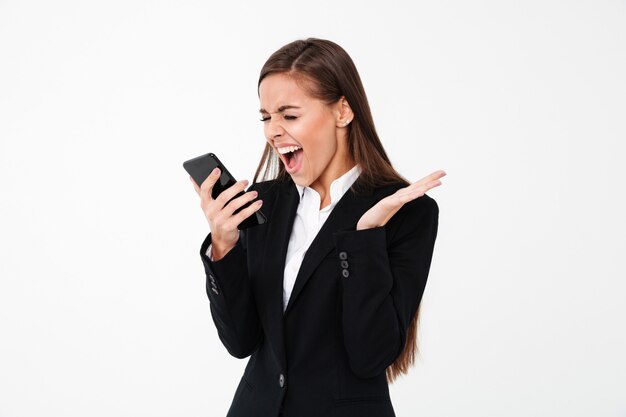 Angry screaming businesswoman using phone