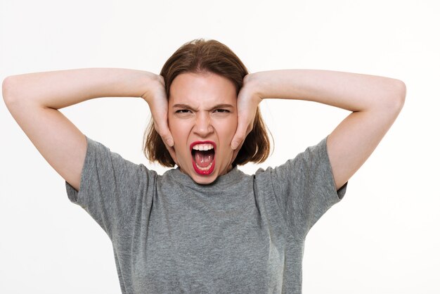 Free photo angry screaming young caucasian lady standing isolated
