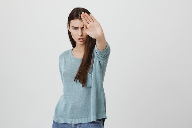 Angry serious woman show stop sign, prohibit or disapprove