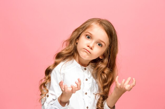 Angry teen girl standing on trendy blue studio.