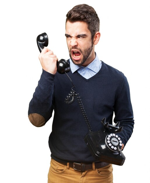 Angry teenager yelling at handset