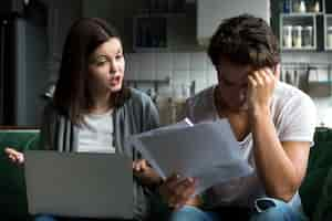 Free photo angry wife scolding blaming upset husband of unpaid bills