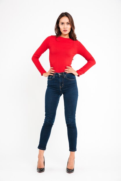 Angry woman posing isolated over white wall background