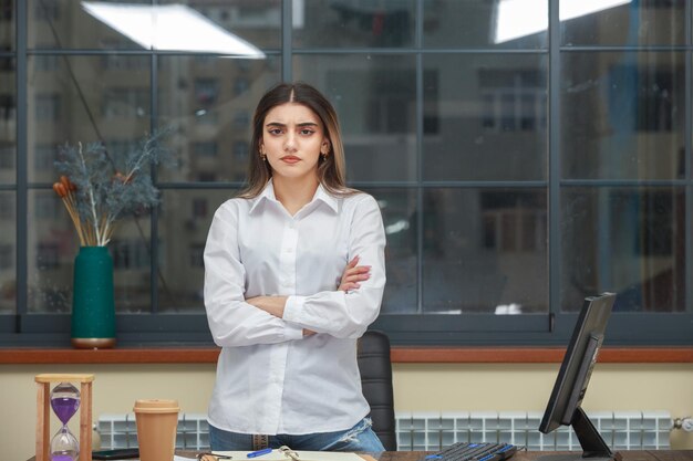 Angry young businesswoman crossed her arms and looking at the camera