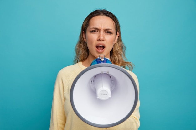 Free photo angry young girl shouting in loud speaker