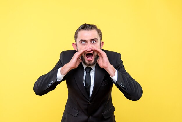 Angry young man calling someone on yellow