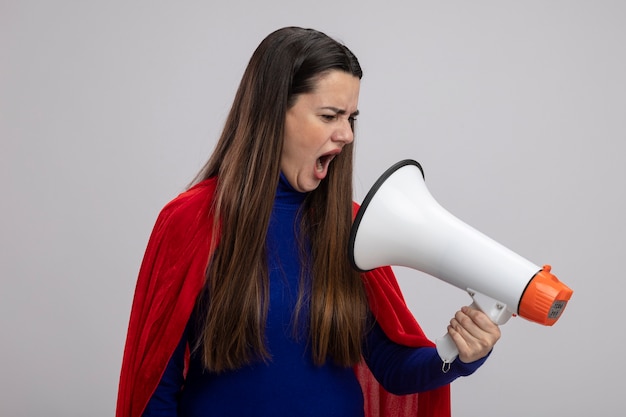 Angry young superhero girl speaks on loudspeaker isolated on white