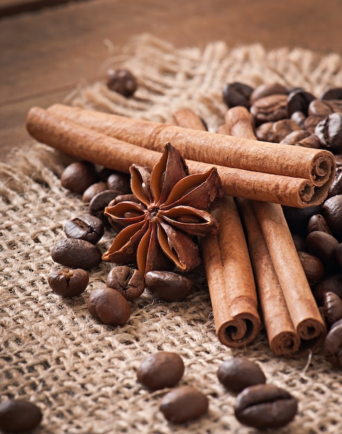 Anise, cinnamon and coffee beans on old wooden background