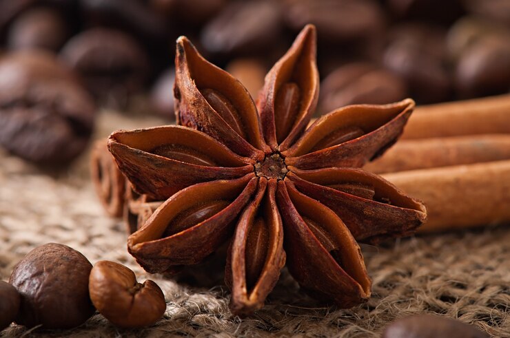 Free Photo anise, cinnamon and coffee beans on old wooden background