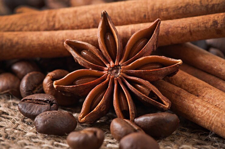Free Photo anise, cinnamon and coffee beans on old wooden background