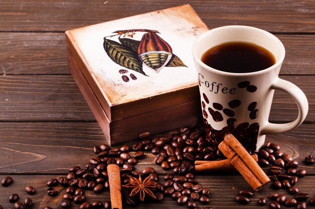 Anise-tree lies on coffee beans  before a cup of coffee