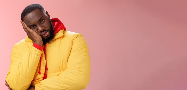 Annoyed bothered pissed africanamerican bearded man in yellow jacket facepalm look angry camera irri