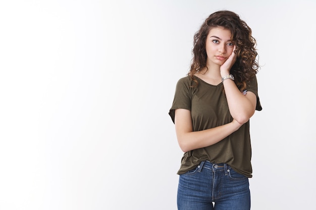 Annoyed fed up attractive tired young woman exhausted hearing boring conversation lean head palm look irritated dying from boredom, look indifferent lack of interest, standing white background