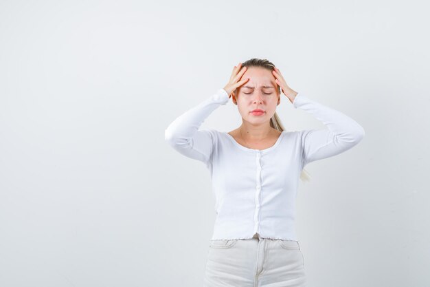 Annoyed girl is showing her head on white background