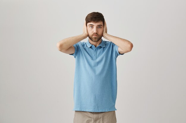 Annoyed young bearded man posing