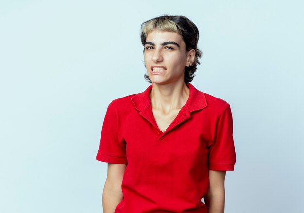 Annoyed young caucasian girl with pixie haircut looking at camera isolated on white background with copy space