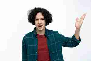 Free photo annoyed young handsome man looking at camera showing empty hand isolated on white background