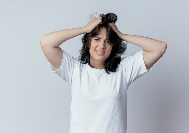 Annoyed young pretty caucasian girl pulling her hair isolated on white background