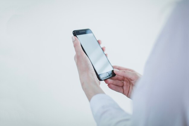 Anonymous businesswoman with smartphone