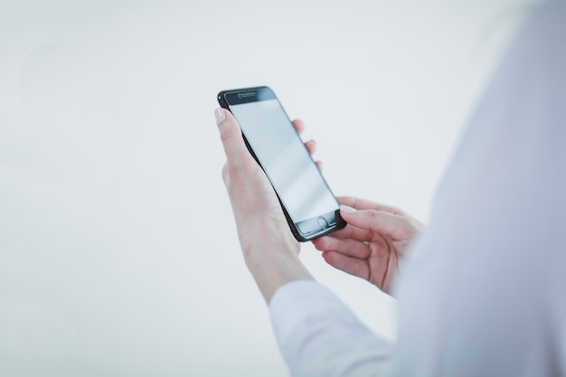 Anonymous businesswoman with smartphone