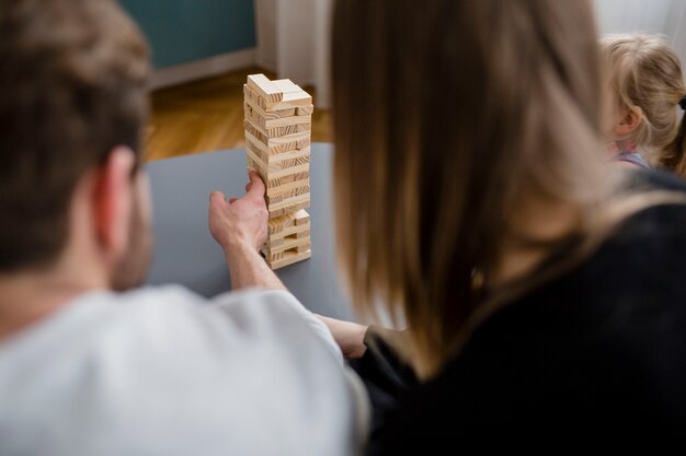 Anonymous family playing jenga