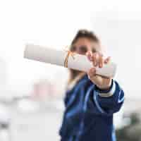 Free photo anonymous lady demonstrating diploma