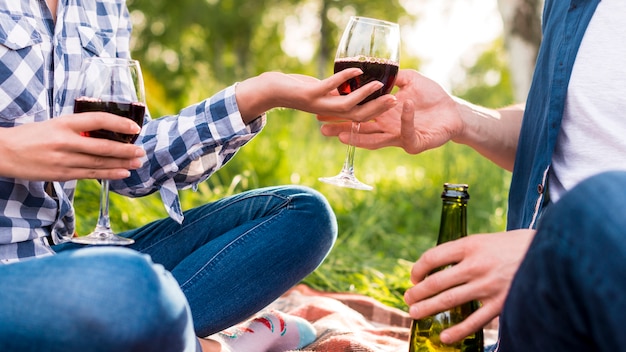 Anonymous lovers giving glass of wine each other