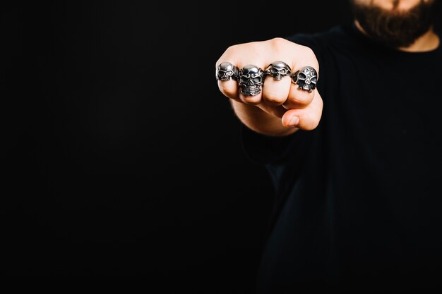 Anonymous man showing fist in rings