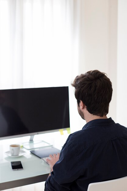 Anonymous man using computer in office