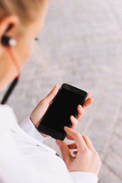 Anonymous sportswoman using smartphone