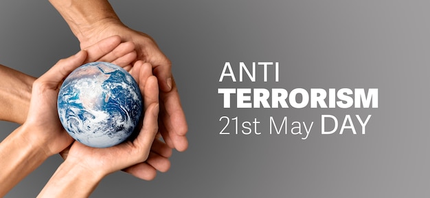 Anti terrorism day with hands holding planet earth