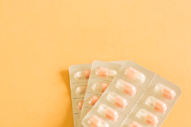 An antibiotic capsules blister package over yellow background