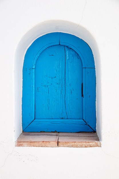 an antique blue wooden window