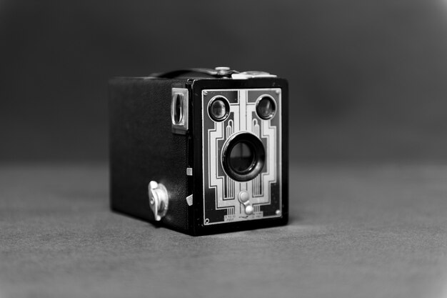 Antique box camera on grey table