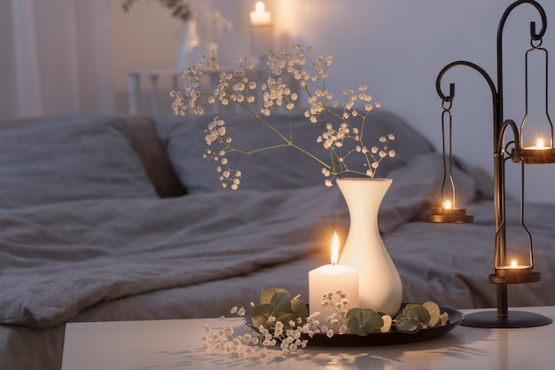 Night interior of bedroom with flowers and burning candles | Premium Photo