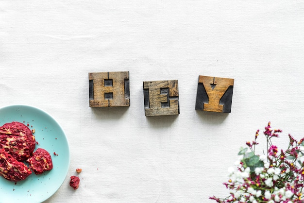 Free photo antique grunge letter cube spelling hey greeting concept